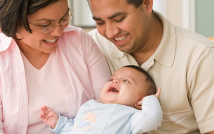 Parents holding their baby.