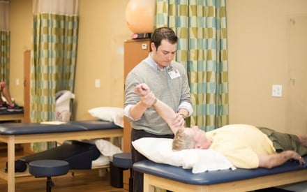 A physical therapist providing treatment for a patient.