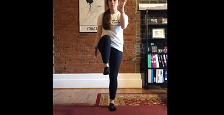 A physical therapist demonstrates "pick a popsicle stick" fun game for physical activity.