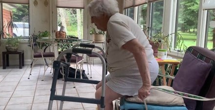 An older adult demonstrates the sit-to-stand exercise.