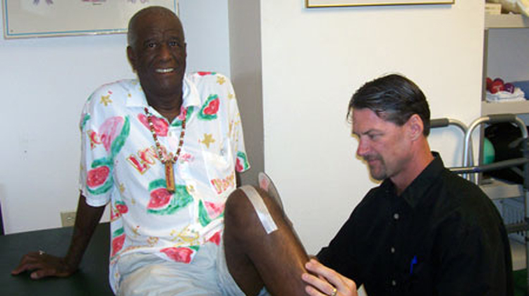 Wally (Famous Amos) being treated by his physical therapist.