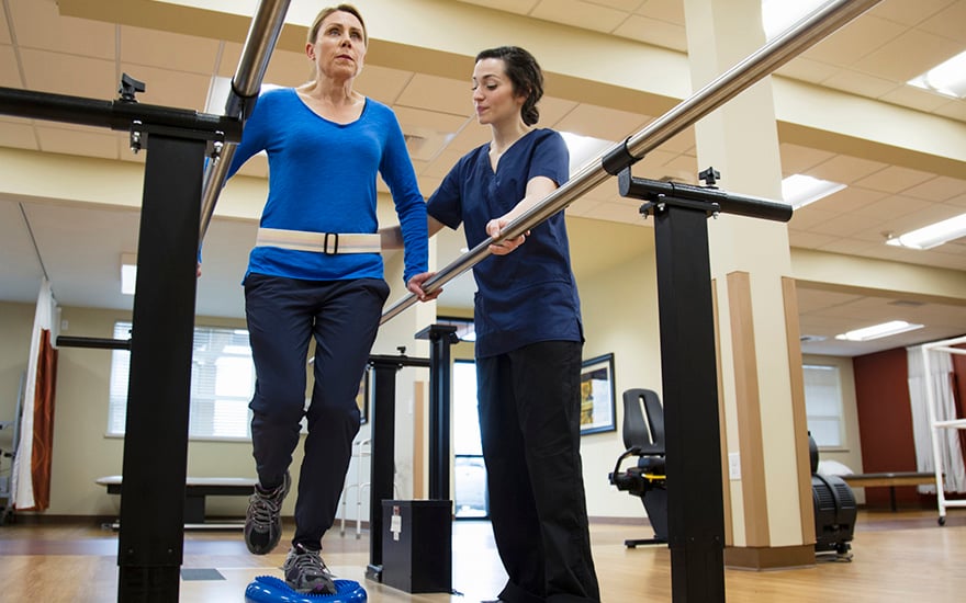 Physical therapist working with a patient on balance