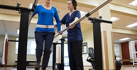 Physical therapist working with a patient on balance