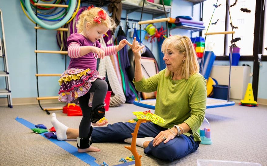 PT working with a child on developmental skills