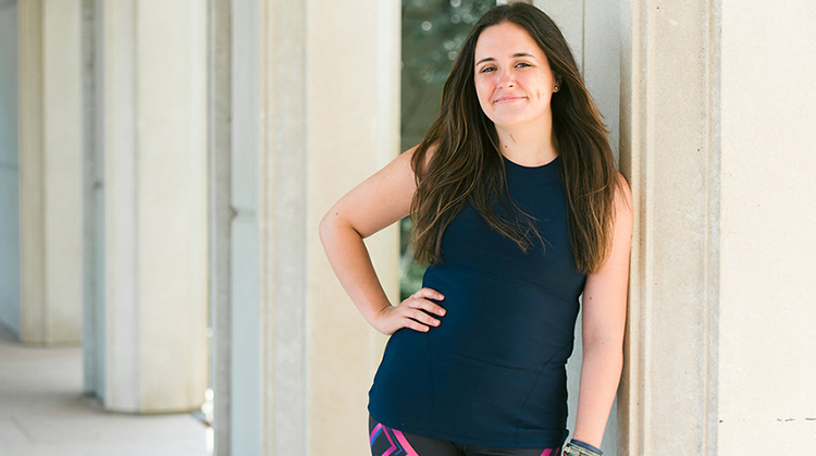 Erin Jackson standing, leaning against a wall.