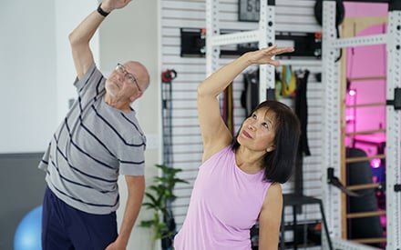 A man and woman doing gentle stretching exercises