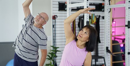 A man and woman doing gentle stretching exercises