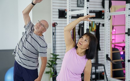 A man and woman doing gentle stretching exercises