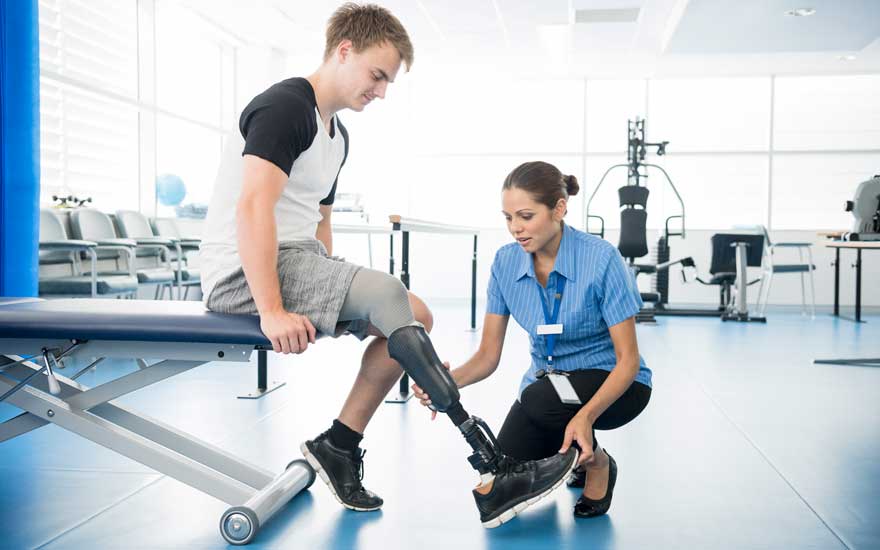 A PT working with a patient with a leg amputation.