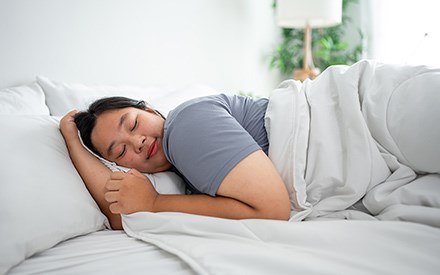 A woman sleeping on a comfortable mattress