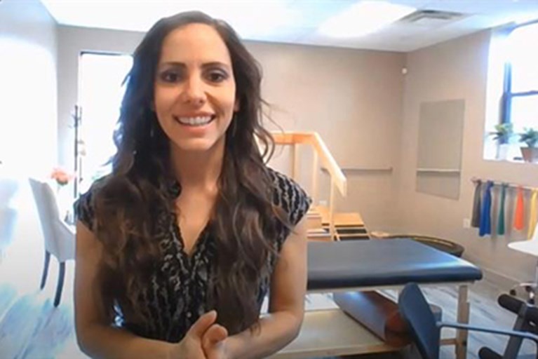 A physical therapist on video, explaining exercises for upper back and neck strain from office work.