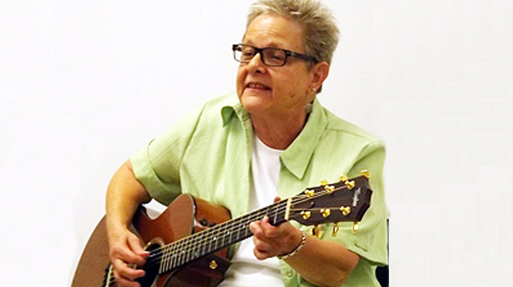 Pam playing the guitar