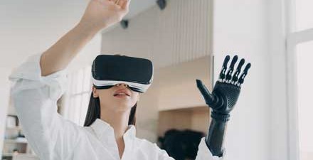 A women with a prosthetic hand using virtual reality during physical therapy