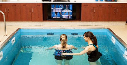 A physical therapist providing aquatic therapy to a patient