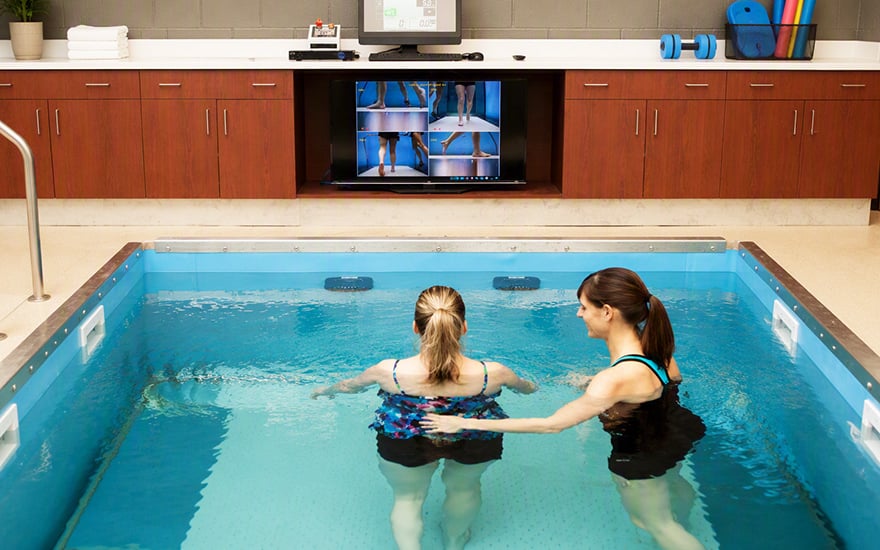 A physical therapist providing aquatic therapy to a patient