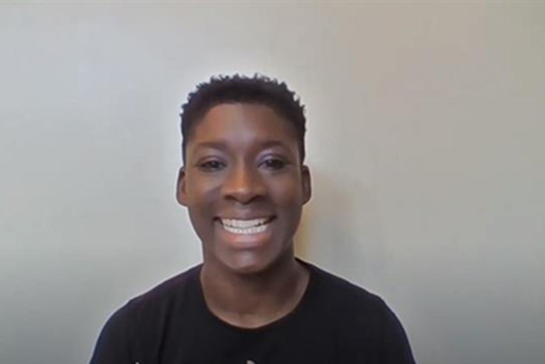 A physical therapist smiles, explaining exercises on video