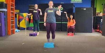 A physical therapist assistant leads an exercise program for kids of all abilities.