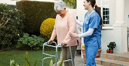 A physical therapist working with a patient at home