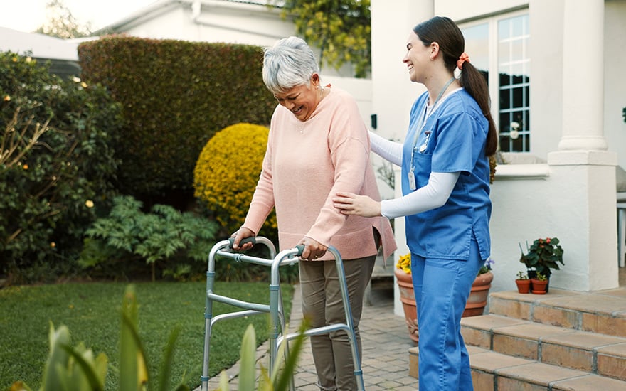 A physical therapist working with a patient at home