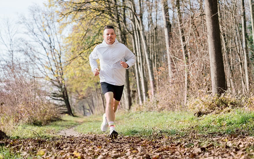 Man running on an outdoor trail.