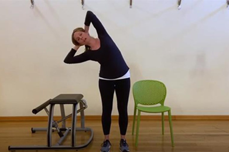 A physical therapist demonstrates exercises for office workers.