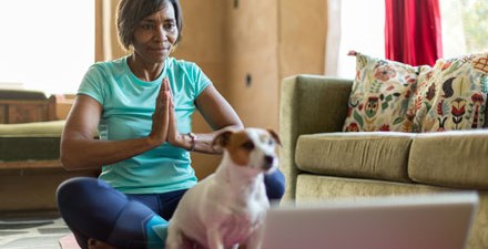A woman doing yoga in her home.