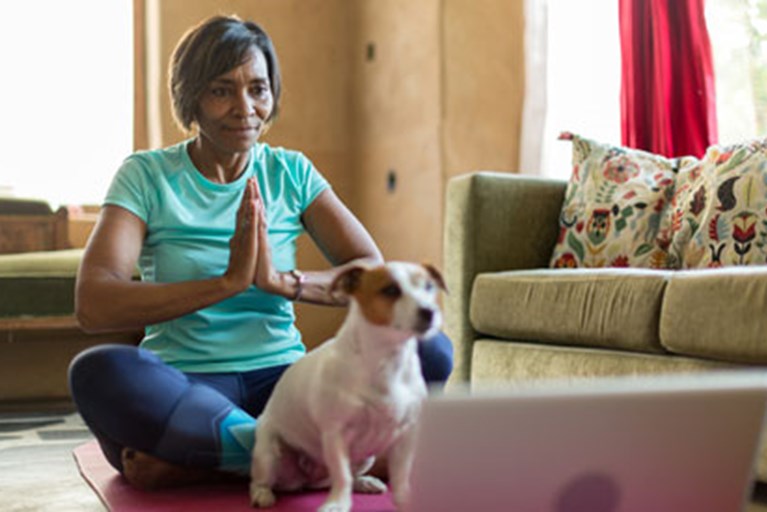 A woman doing yoga in her home.