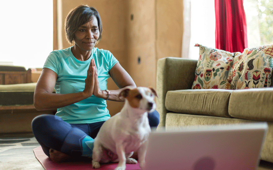 A woman doing yoga in her home.