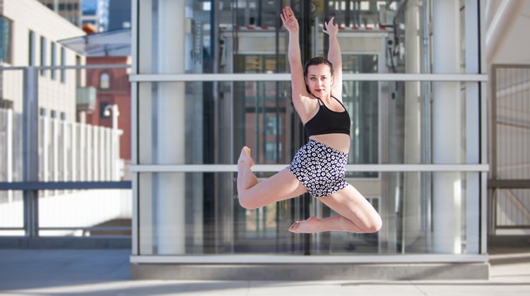 Isabella, leaping in the air with a dance move.