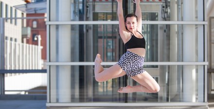 Isabella, leaping in the air with a dance move.