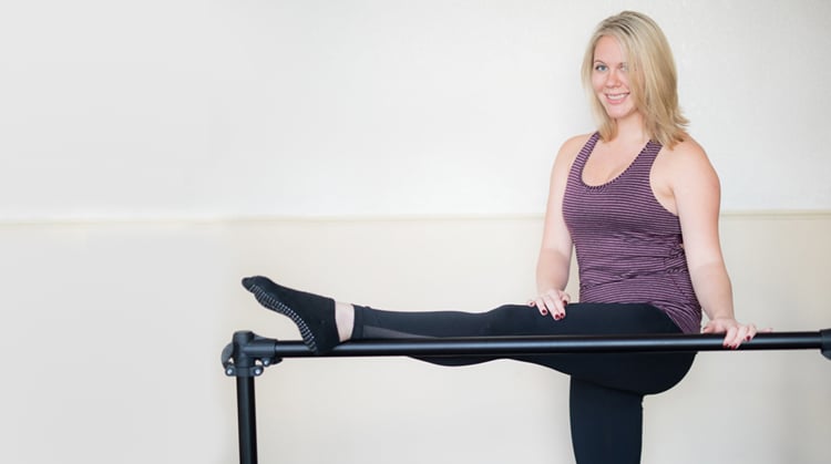 Morgan, with her foot on a ballet barre.