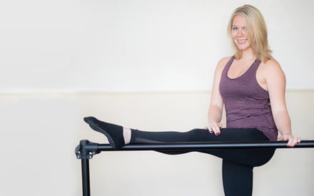 Morgan, with her foot on a ballet barre.