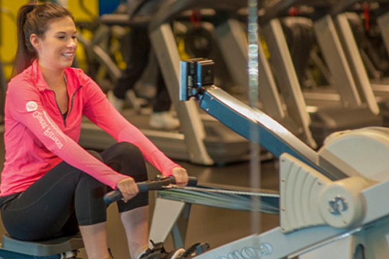 Elizabeth, riding a rowing machine.