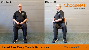 A physical therapist shows how to do a trunk rotation exercise.