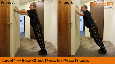 A physical therapist shows how to do a chest press exercise against a wall.