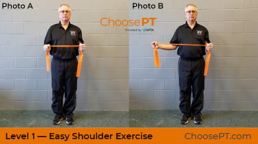 A physical therapist shows how to do a shoulder exercise using an elastic band.