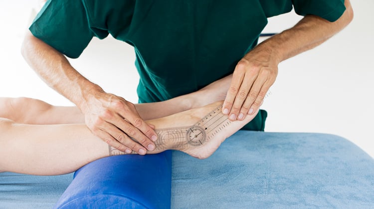 A physical therapist measures the range of motion of a person's ankle.