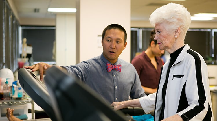 A physical therapist working with an older adult