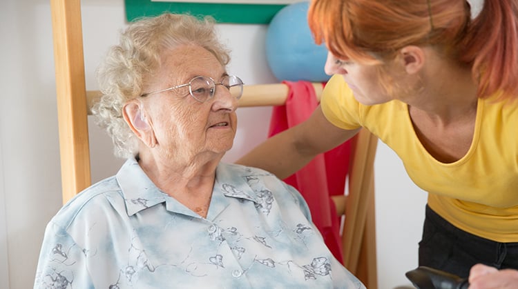 A physical therapist working with an older adult