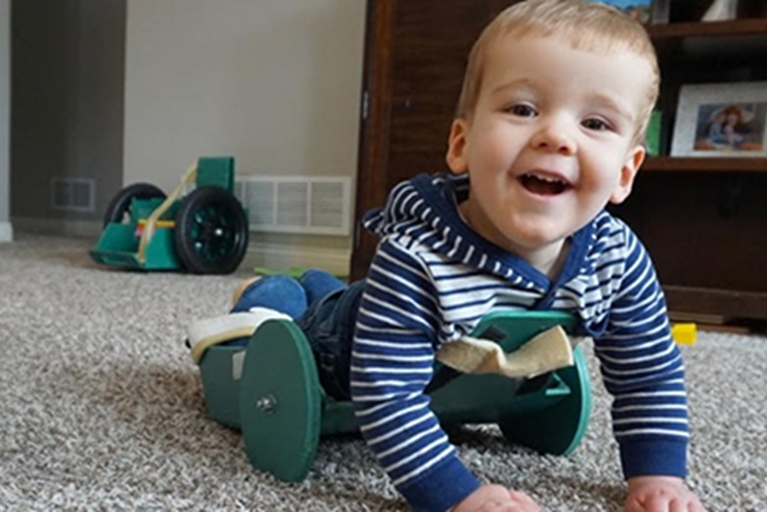 Brody, crawling on the ground, able to be mobile.