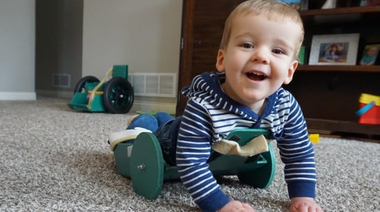 Brody, crawling on the ground, able to be mobile.