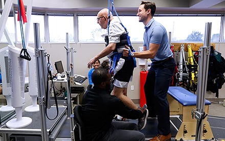 PT working with aged-patient in suspension walking treatment