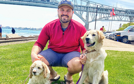 Ted DeChane, PT, DPT, outside with his dogs.