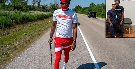 Terry Willis, a black man walking on the road during his 1,000-mile walk for justice.