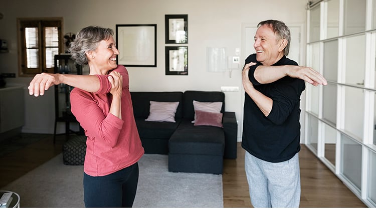 A couple exercising in their living room