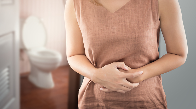 Woman grabbing her stomach in discomfort.