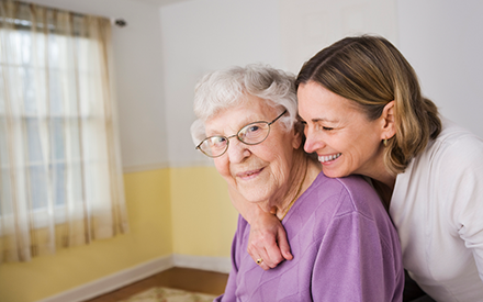 An older adult and her caregiver.