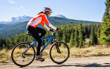 Woman cycling outside.