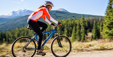 Woman cycling outside.