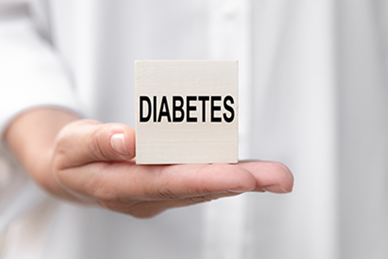 Doctor holding a block witht the word diabetes.